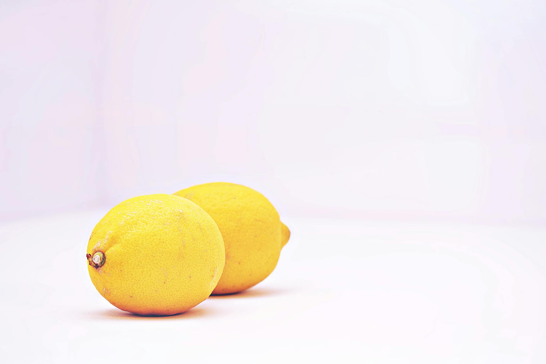 Bright ripe lemons with pleasant aroma arranged on a pastel background, symbolizing cycle phases