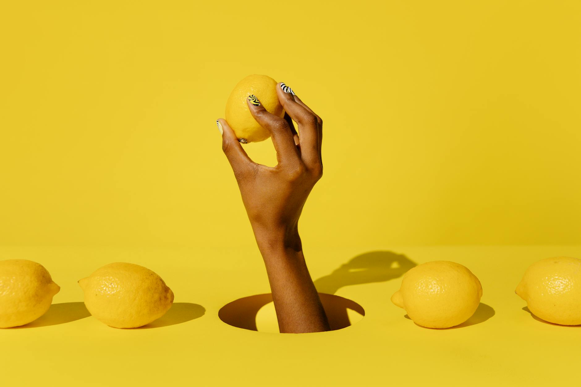 Bright yellow lemons arranged on a pastel background, symbolizing freshness and natural comfort